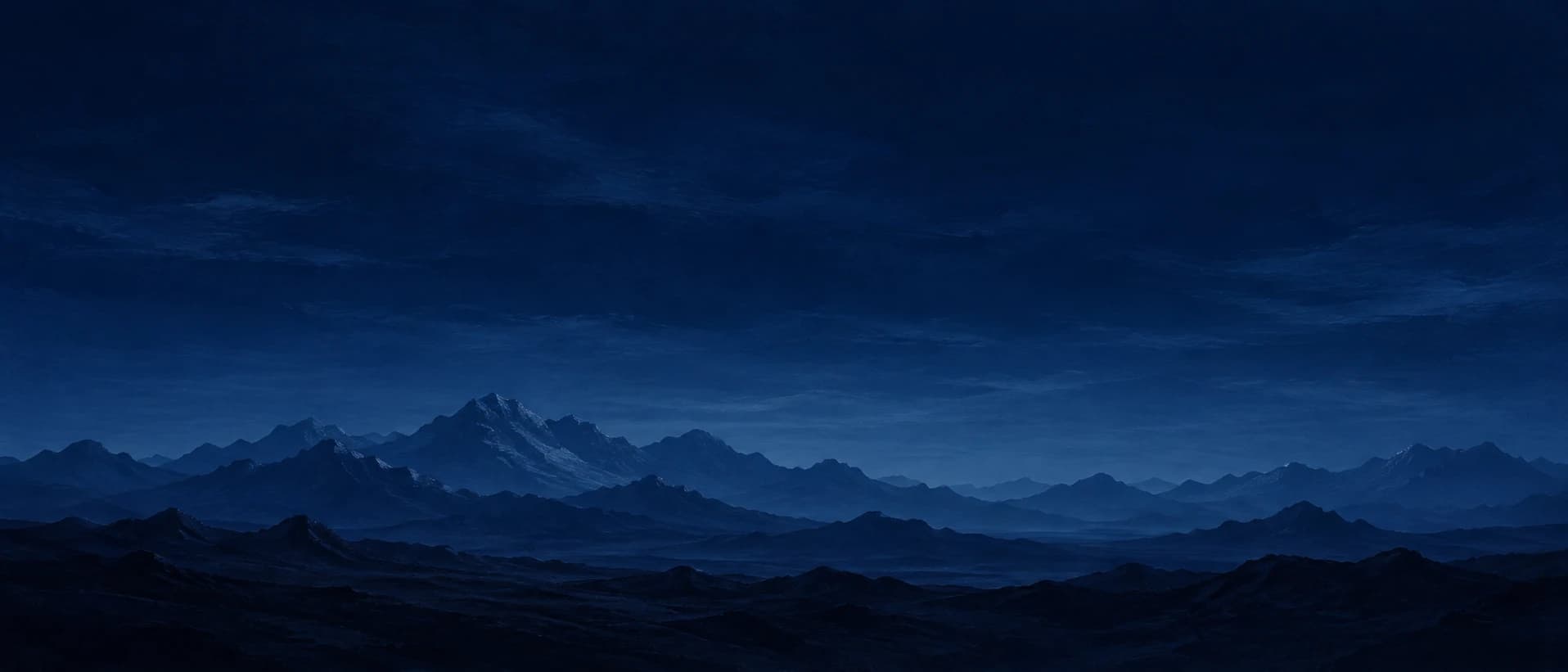 Night mountain range under a deep blue sky